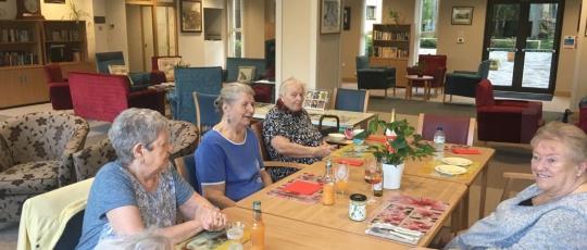 Home residents sitting around a table