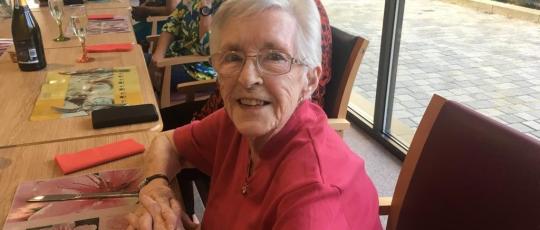 Smiling resident sitting at a table