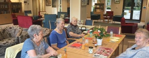 Home residents sitting around a table