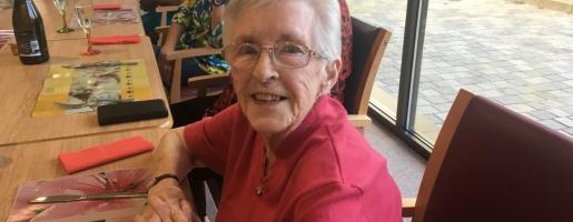 Smiling resident sitting at a table