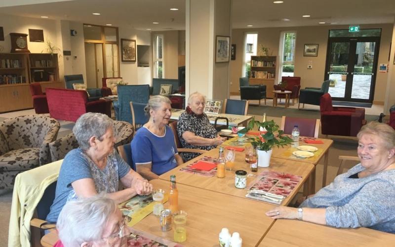 Home residents sitting around a table