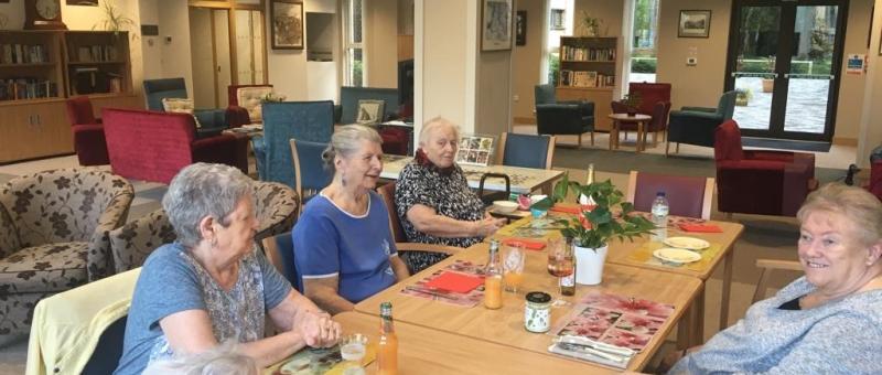 Home residents sitting around a table